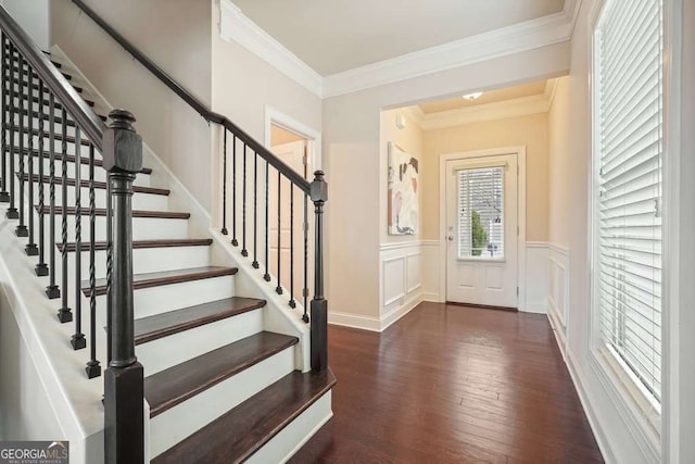 entrance foyer featuring crown molding and dark hardwood / wood-style floors