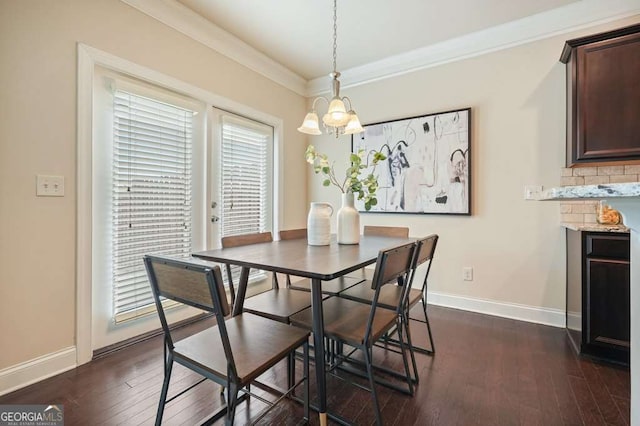 dining room with crown molding and dark hardwood / wood-style floors