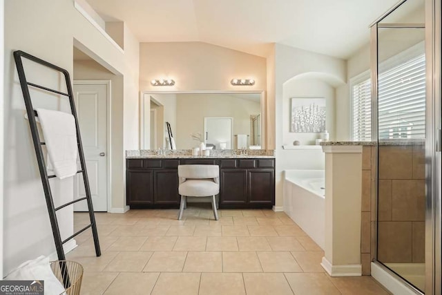 bathroom with lofted ceiling, vanity, tile patterned flooring, and separate shower and tub