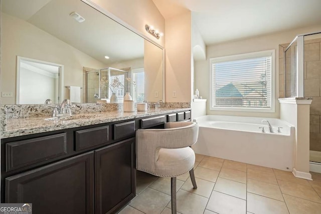 bathroom featuring independent shower and bath, vanity, lofted ceiling, and tile patterned floors