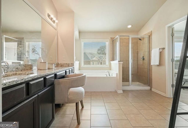 bathroom featuring a wealth of natural light, tile patterned floors, and plus walk in shower