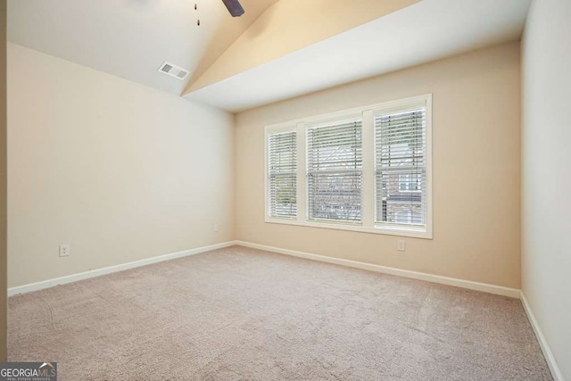 unfurnished room featuring lofted ceiling, light carpet, and ceiling fan