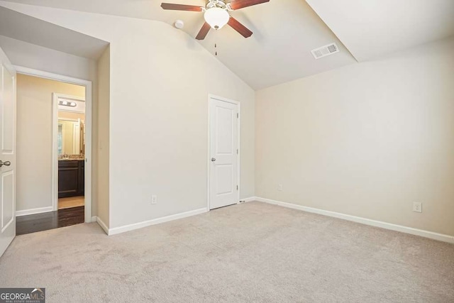 unfurnished bedroom featuring ceiling fan, light colored carpet, and lofted ceiling