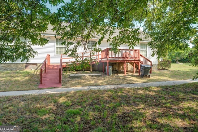 exterior space with stairs, a front yard, and a wooden deck