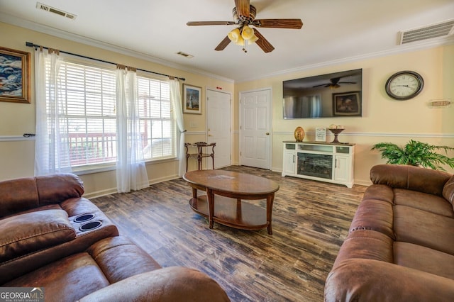 living area featuring a fireplace, visible vents, and ornamental molding