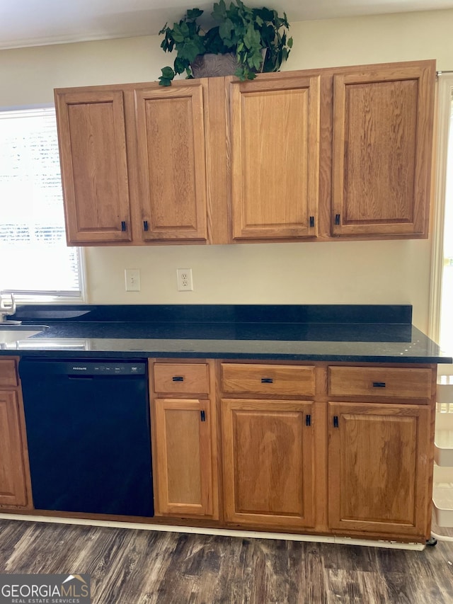 kitchen featuring dishwasher, dark countertops, dark wood-style flooring, and brown cabinets