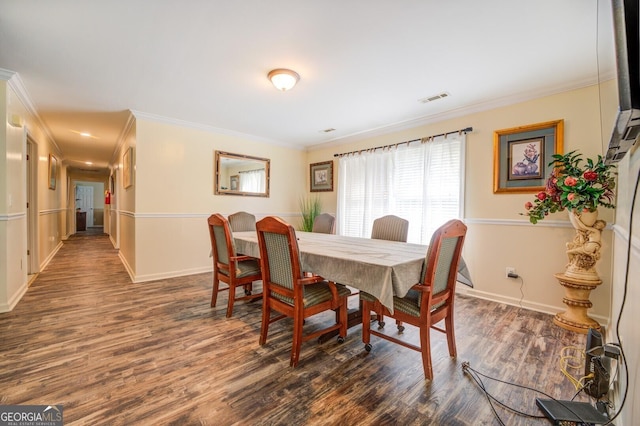 dining room featuring crown molding, wood finished floors, visible vents, and baseboards