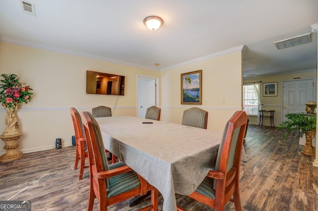 dining area featuring visible vents, wood finished floors, and ornamental molding