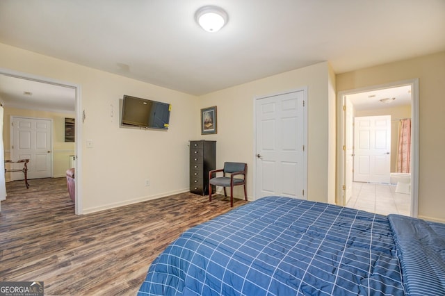 bedroom featuring baseboards and wood finished floors