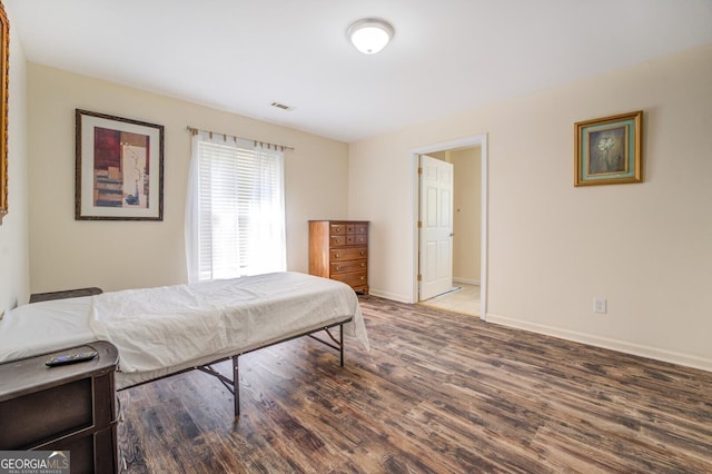 bedroom featuring dark hardwood / wood-style flooring