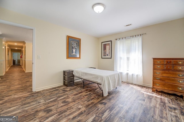 bedroom with dark wood-type flooring