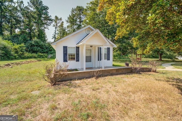 bungalow-style home with a front lawn