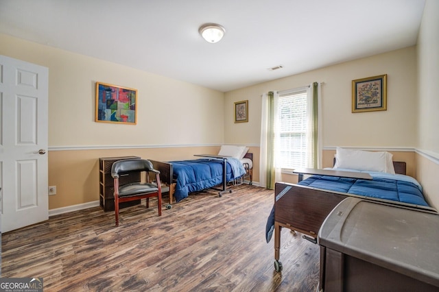 bedroom with dark wood-type flooring