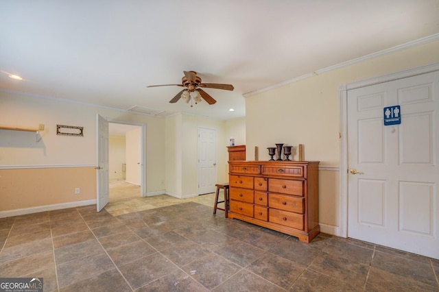 interior space with a ceiling fan, baseboards, recessed lighting, stone finish floor, and crown molding