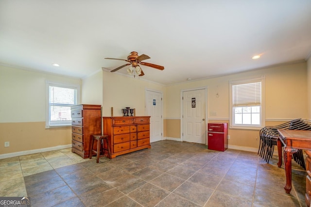 interior space featuring recessed lighting, baseboards, plenty of natural light, and crown molding