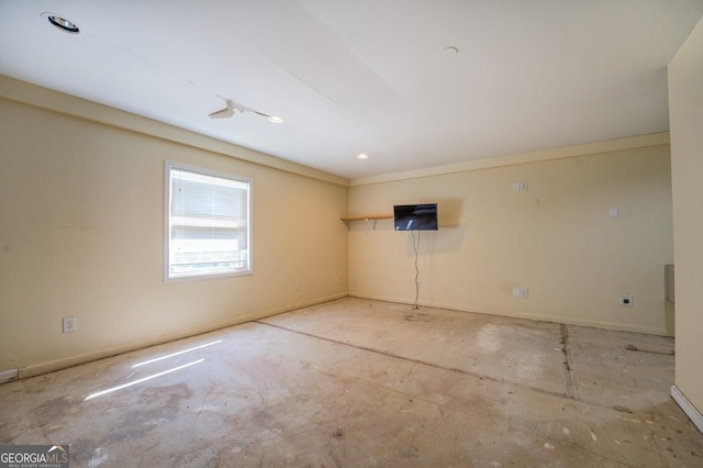 unfurnished room featuring baseboards