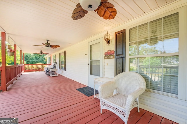 wooden terrace featuring ceiling fan and covered porch