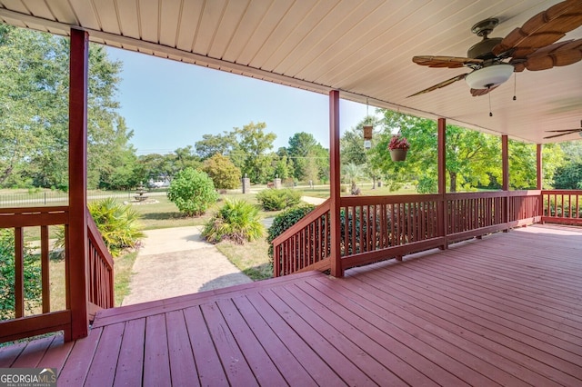 wooden terrace featuring ceiling fan