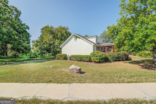 view of side of home featuring a yard