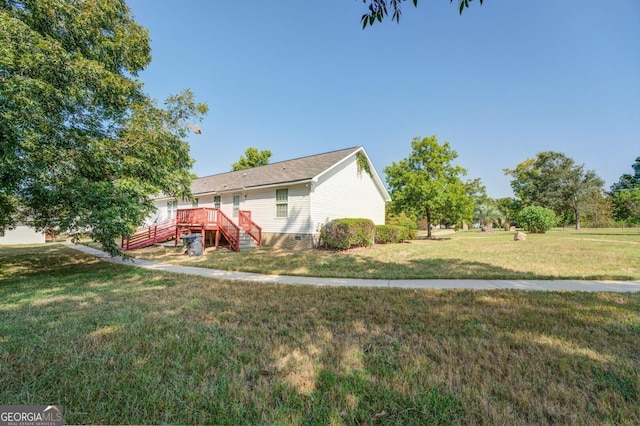 view of front of property with a wooden deck and a front lawn