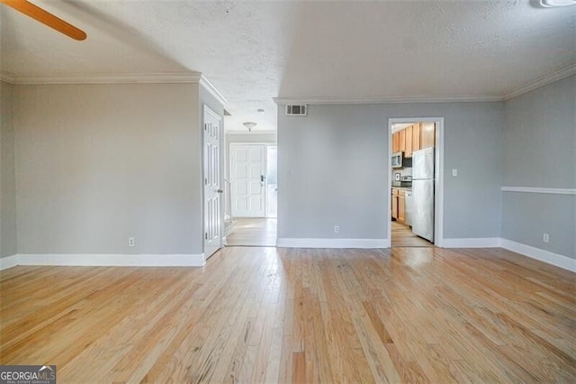 unfurnished room featuring crown molding, a textured ceiling, and light wood-type flooring