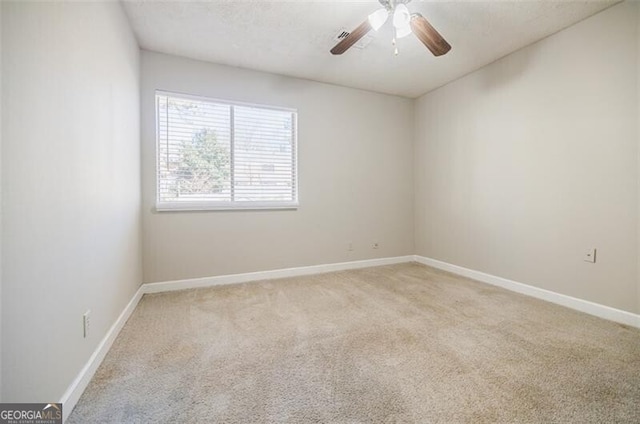 empty room with light carpet, a textured ceiling, and ceiling fan