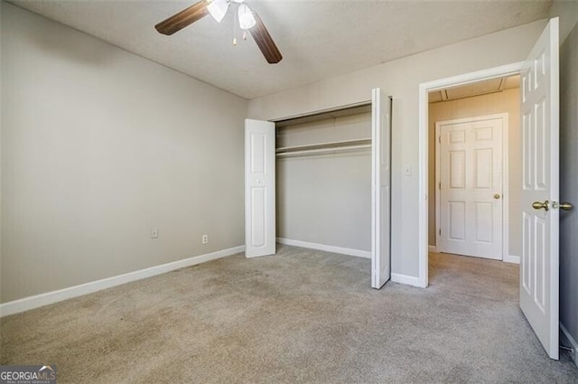 unfurnished bedroom featuring light carpet, a closet, and ceiling fan