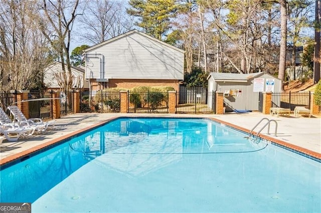 view of pool with an outbuilding and a patio area