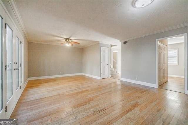 spare room with crown molding, ceiling fan, light hardwood / wood-style floors, and a textured ceiling