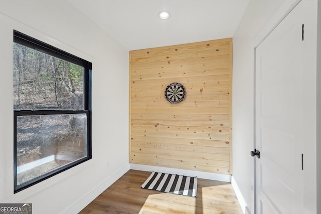 interior space featuring dark wood-type flooring and wooden walls