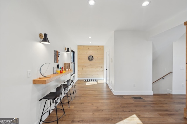 corridor featuring wooden walls and hardwood / wood-style floors