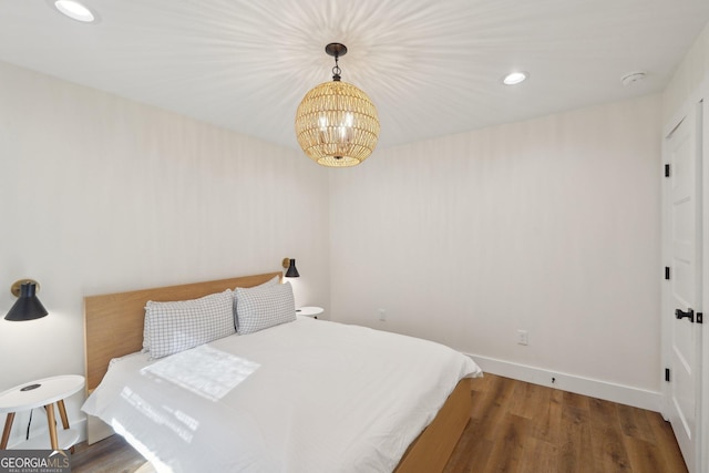 bedroom with dark hardwood / wood-style flooring