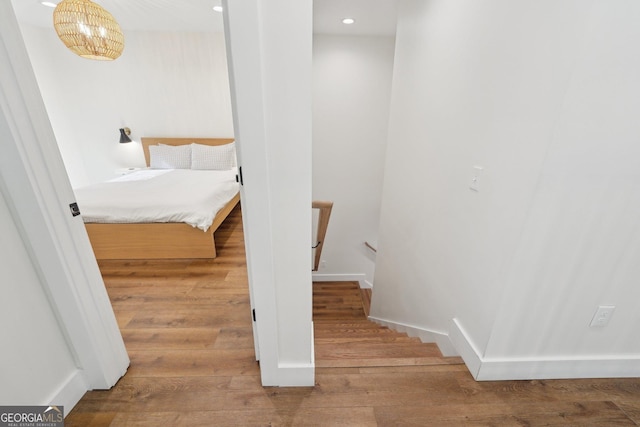 staircase with hardwood / wood-style flooring