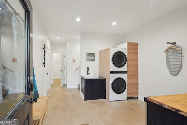 washroom featuring stacked washer / drying machine