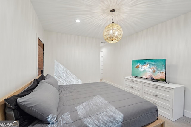 bedroom with a notable chandelier