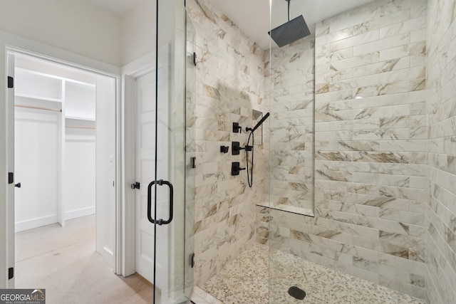 bathroom with a shower with door