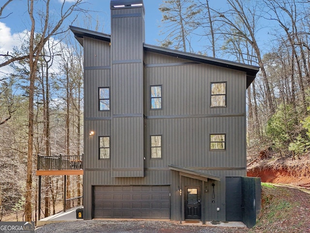 581 Etowah Trl, Dahlonega, GA 30533 - view of property exterior with an attached garage, a chimney, and driveway
