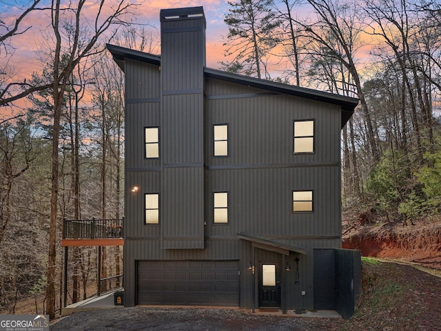 property exterior at dusk featuring a garage