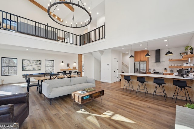 living room with a notable chandelier and light wood-type flooring