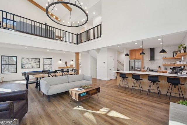 581 Etowah Trl, Dahlonega, GA 30533 - living area with a towering ceiling, light wood-type flooring, recessed lighting, a chandelier, and stairway