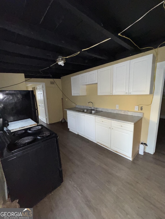 kitchen featuring sink, black appliances, hardwood / wood-style floors, and white cabinets