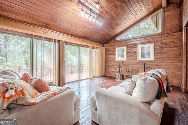 living room featuring wood ceiling, lofted ceiling, a healthy amount of sunlight, and wood walls