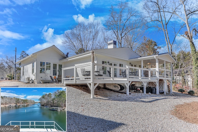 back of house with a deck with water view