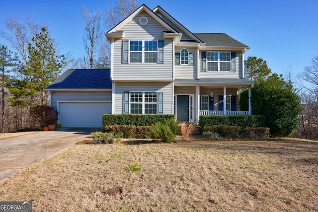 view of front of home with a garage, a front lawn, and a porch