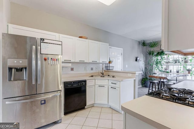 kitchen featuring white cabinets, dishwasher, sink, and stainless steel fridge