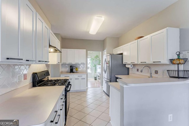 kitchen featuring light tile patterned floors, stainless steel fridge, black range with gas cooktop, white cabinets, and decorative backsplash