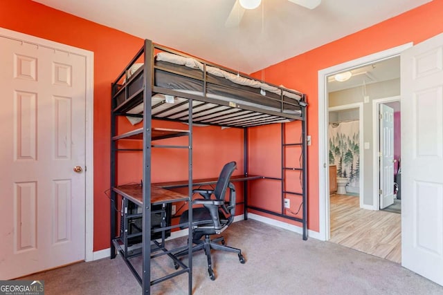 carpeted bedroom featuring attic access and baseboards