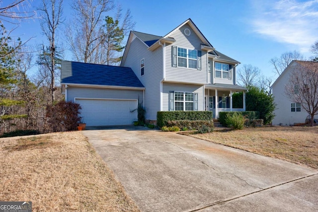 front of property featuring a porch, a garage, and a front yard