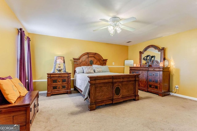 bedroom with a ceiling fan, light carpet, visible vents, and baseboards