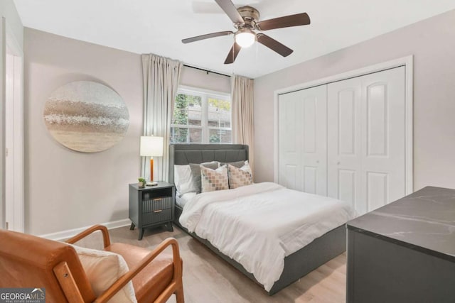 bedroom featuring wood-type flooring, a closet, and ceiling fan